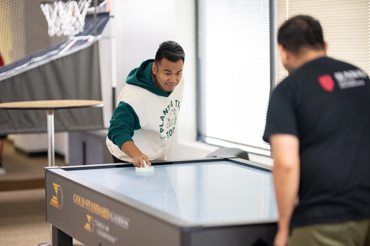 Karan Shrestha and Ayush Ojha play air hockey in the new Student Lounge.