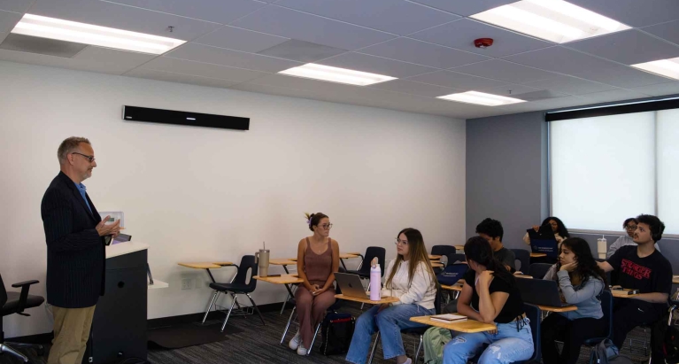 Michael talking to a group of students in the classroom