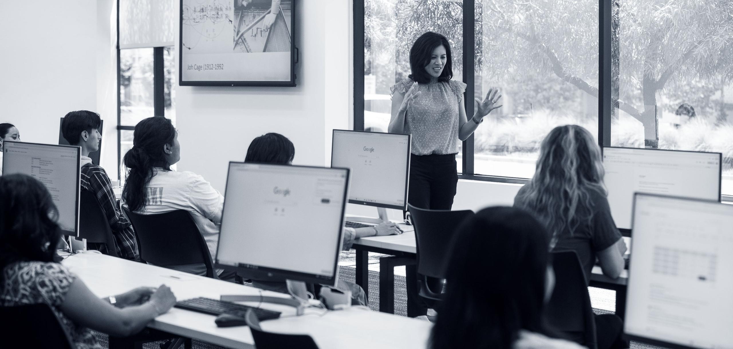 Teacher in front of computer lab class