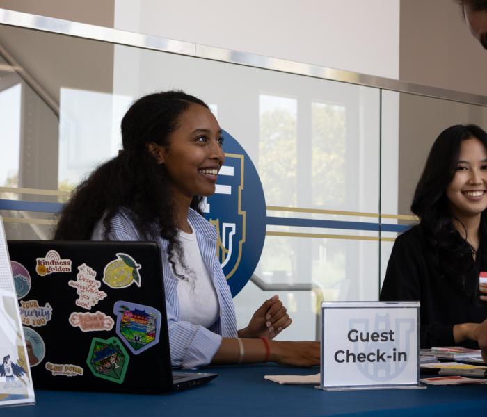 Staff member checking students in