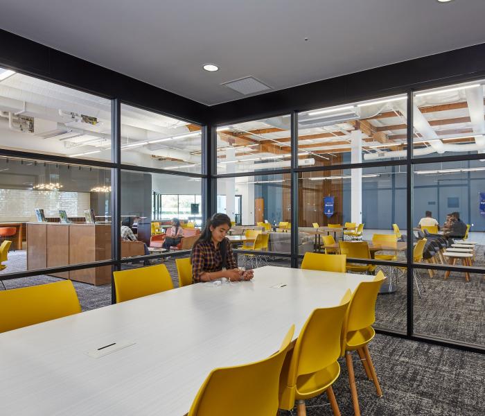 Student studying in the enclosed glass study space