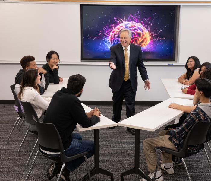 President in front of classroom