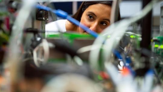 Photo Of Female Engineer Looking Through Wires