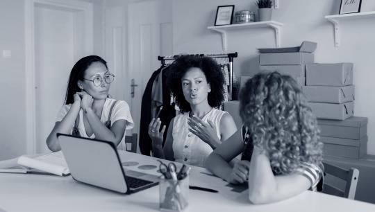 women in front of a laptop