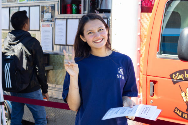student giving peace sign