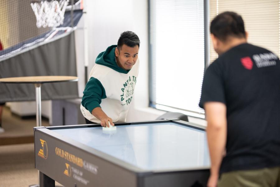 Students playing air hockey